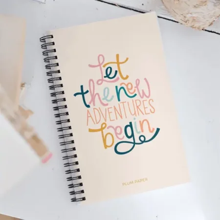 A spiral-bound notebook with a light cream cover