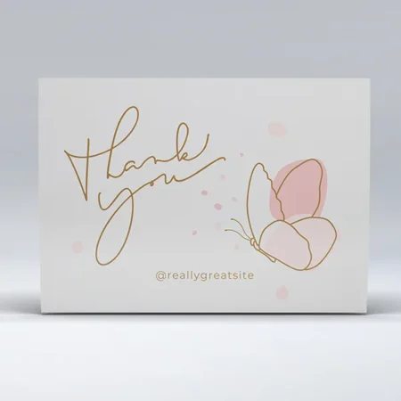 A simple thank you card with gold cursive text and a pink watercolor butterfly design.